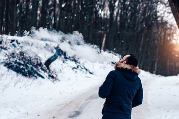 Man with beard vape electronic cigarette outdoor