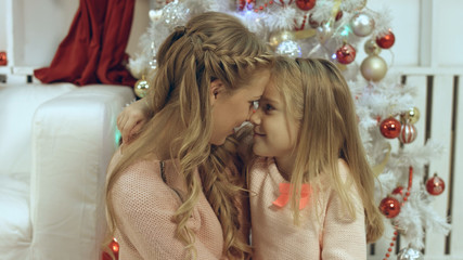Obraz na płótnie Canvas Happy mother and daughter near the a Christmas tree