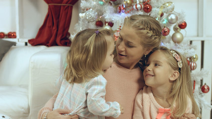 Heart-piercing family consisting of a mother and two young daughters in the new year