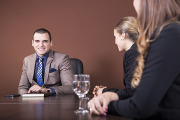Business partners discussing documents at the meeting.