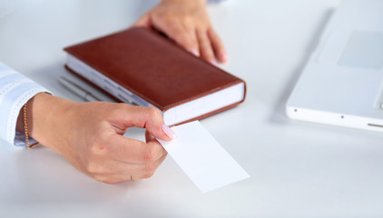 Businesswoman holding blank visit card ,sitting on the desk