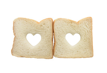 Heart shaped hole in a slice of bread isolated