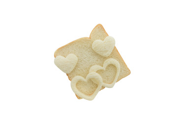 Heart shaped hole in a slice of bread isolated