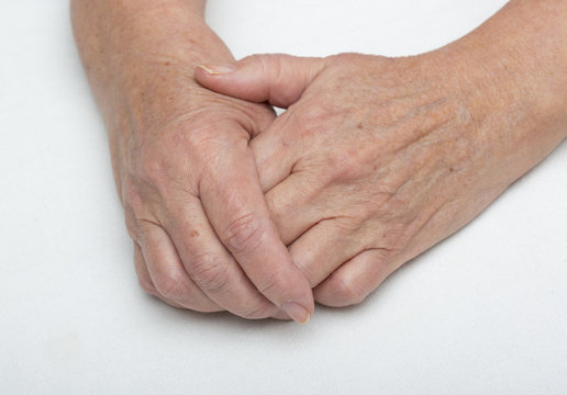 Hands of an older woman. Elderly woman is holding her hands together.