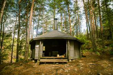 Fototapeta na wymiar A beautiful small wooden building in the middle of Finnish forest
