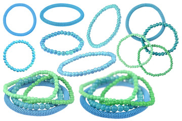 Many instances of blue and green elastic bracelets made of pearl