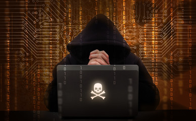 Hacker using laptop. Hacking the network.