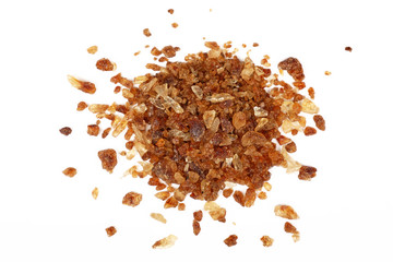 Pinch of brown caramel sugar spilled on white