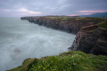 Obraz premium The high tide reaches the cliffs of the beach of As Catedrais