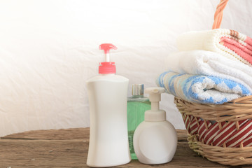 Obraz na płótnie Canvas Shower gel with Skin cream and bath towels in basket