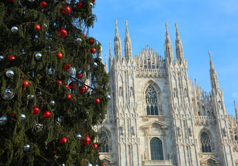 huge Christmas tree with red balls and silver and the facade of