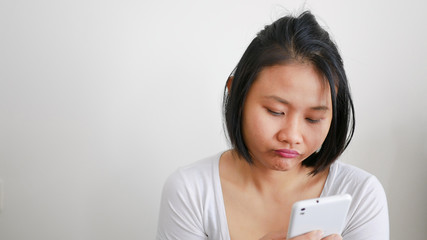 Upset stressed woman holding cellphone disappointed with message