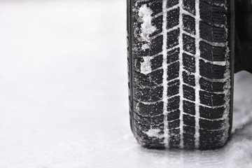 Car tires on winter road. Beautiful winter seasonal  background.