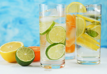 detox mineral water with lime, tangerine and lemon on a light background