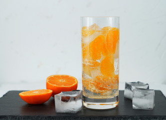 detox mineral water with tangerine on black and white background