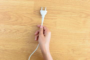 hand holding electric plug