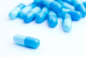 close up of blue medical capsules isolated on white background