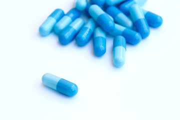 close up of blue medical capsules isolated on white background