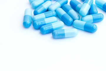 close up of blue medical capsules isolated on white background