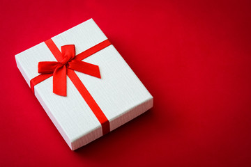 San Valentine white gift box on red background.Love concept Copyspace.
