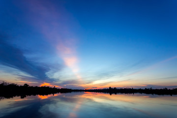 Fototapeta na wymiar Sunset with reflection on the lake