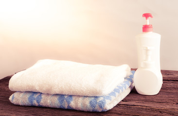 Fototapeta na wymiar Shower gel with Skin cream and bath towels
