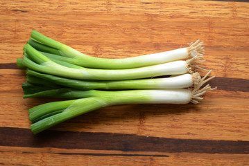 Fototapeta premium Sliced, chopped spring onions, salad onions, green onions or scallions on wood background