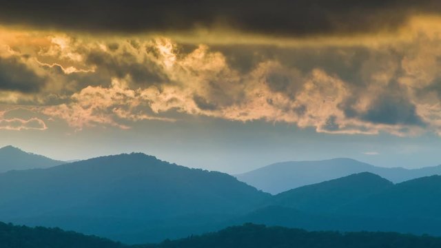 Fire Like Clouds Glowing by Golden Sunlight Moving Over Layers of the Blue Ridge Mountains in Western North Carolina