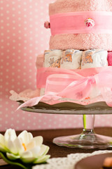 diaper cake with pink background for the new birth of a child