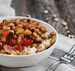 Homemade Southern Hoppin John or Carolina peas and rice served in awhite bowl