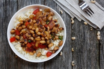Homemade Southern Hoppin John or Carolina peas and rice served in awhite bowl