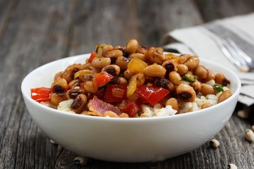 Homemade Southern Hoppin John or Carolina peas and rice served in awhite bowl
