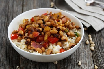 Homemade Southern Hoppin John or Carolina peas and rice served in awhite bowl