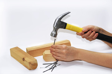 Woman hand with hammer and nails.