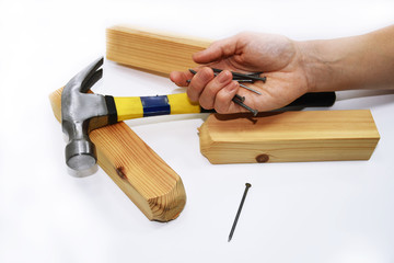Woman hand with hammer and nails.