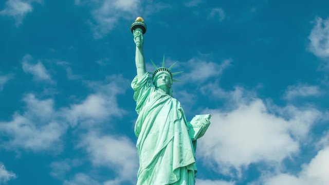 Statue of Liberty - Medium Shot, Slowly Zooming-out with White Clouds Moving in a Blue Sky Background on a Sunny Day
