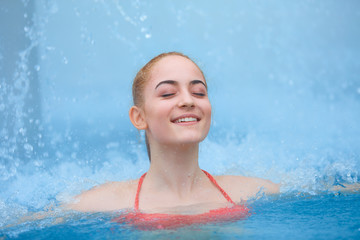 Young girl relaxing in thermal pool