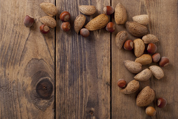 almonds and nuts on wooden background