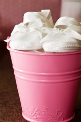 pink bucket with girl shoes