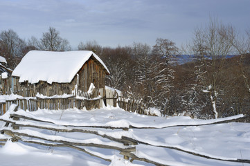 Wooden rural house in winter.