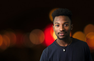 young man in the city at night downtown illuminated street