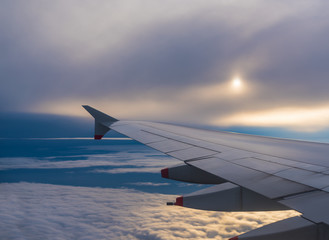 Airplane flying on a cloudy sky