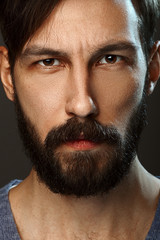 Obraz premium Closeup portrait of serious man with beard and mustache looking