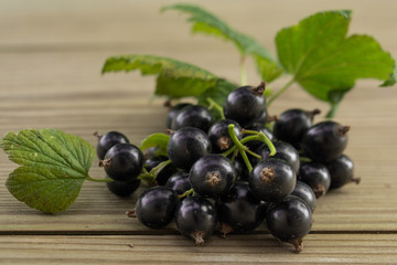 Millstone currants on a wooden table, ripe currants, berries, food for sale, small business, agriculture,