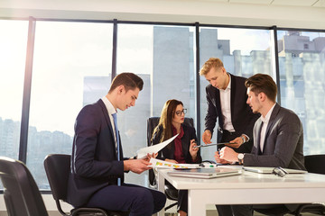 Group of businesspeople working together at a table in the office. Team work.