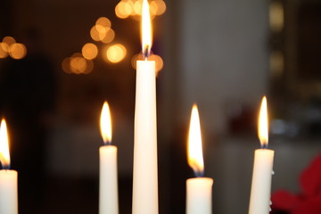 candle flame light at night with bokeh on dark background