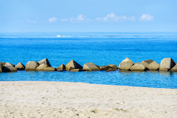 stones breakwater near beach of Tonarella