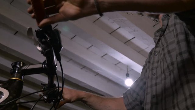 Low angle of a mechanic bleeding disc brakes on a bicycle