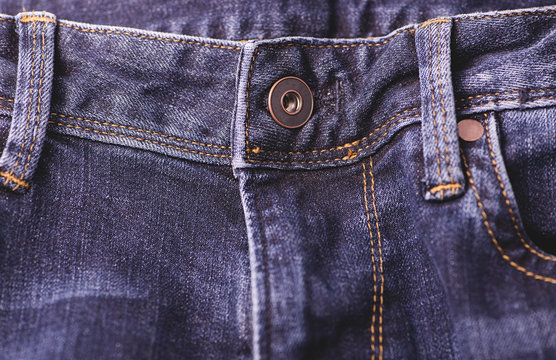 Horizontal shot of a button on a jeans fly