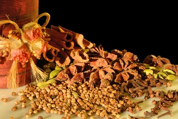 mixed spices and decorated pestle and mortar on marble board